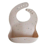 Mushie® Bavoir en silicone Vanilla Confetti